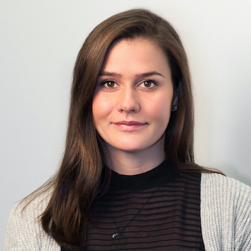 A woman with long brown hair is posing for a single-page Elementor photo shoot.